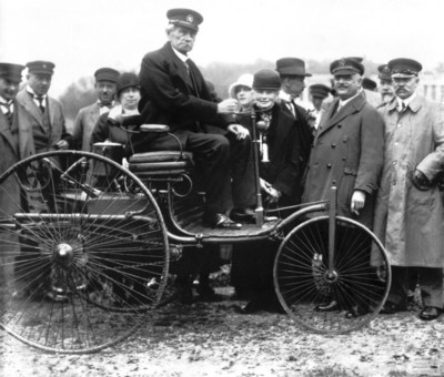Carl Betz in his three-wheel gas-powered automobile.